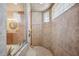 Large, neutral-tiled shower with glass block window at 9461 Redhawk Bend Ln, Lakeland, FL 33810