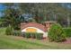 RedHawk community sign with beautiful brick accents, lush landscaping, and welcoming entrance at 9461 Redhawk Bend Ln, Lakeland, FL 33810