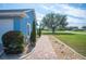 Landscaped walkway leading to home, featuring brick pavers, mature trees and well-maintained lawn at 9461 Redhawk Bend Ln, Lakeland, FL 33810