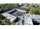 Aerial view showing condo building, parking, and greenery at 1100 Martinique Dr # 106, Winter Haven, FL 33884