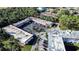 Aerial view showing condo building, parking, and greenery at 1100 Martinique Dr # 106, Winter Haven, FL 33884