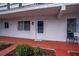 A close up of the front door of the apartment with a small garden area and an assigned parking spot at 1100 Martinique Dr # 106, Winter Haven, FL 33884