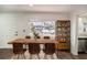 A nicely staged dining area with a large window and a modern decorative display shelf at 1100 Martinique Dr # 106, Winter Haven, FL 33884