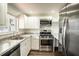 This is a nicely updated kitchen featuring stainless steel appliances, granite countertops and new cabinets at 1100 Martinique Dr # 106, Winter Haven, FL 33884