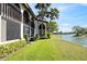 Picturesque backyard overlooking a serene pond surrounded by lush greenery and swaying palm trees at 1103 Country Club Dr # A-3, Lake Wales, FL 33898