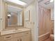Bathroom featuring a single vanity sink and a shower with a pink shower curtain at 1103 Country Club Dr # A-3, Lake Wales, FL 33898