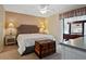 Bedroom with a king size bed, ceiling fan, and a dresser with a mirror at 1103 Country Club Dr # A-3, Lake Wales, FL 33898