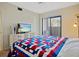 Bedroom with a TV, dresser, closet, ceiling fan, and window with blinds at 1103 Country Club Dr # A-3, Lake Wales, FL 33898