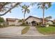 Inviting community clubhouse featuring tile roof, arched entrance, parking and landscaping at 1103 Country Club Dr # A-3, Lake Wales, FL 33898