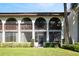 Back view of condo featuring a screened-in porch, well-maintained landscaping and manicured lawn at 1103 Country Club Dr # A-3, Lake Wales, FL 33898
