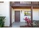 Inviting front door with dark wood finish, house number, and plants adds a welcoming touch at 1103 Country Club Dr # A-3, Lake Wales, FL 33898