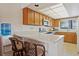 Bright kitchen features wood cabinetry, white countertops, appliances, and a breakfast bar with seating at 1103 Country Club Dr # A-3, Lake Wales, FL 33898