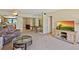 Open-concept living room with a view into the kitchen, a ceiling fan, and comfortable seating at 1103 Country Club Dr # A-3, Lake Wales, FL 33898