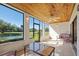 Enclosed outdoor patio featuring a ceiling fan and views of the pond and golf course at 1103 Country Club Dr # A-3, Lake Wales, FL 33898