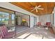 Enclosed patio with tile flooring, ceiling fan, and furniture at 1103 Country Club Dr # A-3, Lake Wales, FL 33898