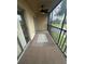 Outdoor patio featuring a ceiling fan, decorative rug, and screened enclosure at 1130 N Lake Parker Ave # E231, Lakeland, FL 33805