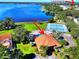 Scenic aerial view showcasing the community clubhouse, pool, tennis courts, and proximity to the lake at 123 Morning Glory Cir, Winter Haven, FL 33884
