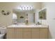 Well-lit bathroom featuring a double sink vanity, a large mirror, and neutral decor at 123 Morning Glory Cir, Winter Haven, FL 33884