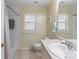 Bright bathroom with a tub and shower, a white toilet and a light countertop at 123 Morning Glory Cir, Winter Haven, FL 33884