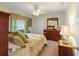 Comfortable bedroom with a floral comforter, wooden furniture, and soft natural lighting at 123 Morning Glory Cir, Winter Haven, FL 33884
