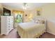 Cozy bedroom with a white bed frame, floral accents, and a view of the outdoors at 123 Morning Glory Cir, Winter Haven, FL 33884