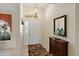 Bright foyer featuring tile flooring, an ornate mirror, a decorative light fixture, and a glass paneled front door at 123 Morning Glory Cir, Winter Haven, FL 33884