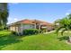 Well-maintained home featuring a tile roof, mature landscaping, and a green lawn at 123 Morning Glory Cir, Winter Haven, FL 33884