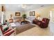 Living room featuring tile flooring, a ceiling fan, two sofas, and a view of the backyard at 123 Morning Glory Cir, Winter Haven, FL 33884