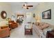 Spacious living room with tile flooring, a ceiling fan, and views into the dining room and entryway at 123 Morning Glory Cir, Winter Haven, FL 33884