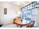 A cozy dining area features a round table and a window with natural light at 125 Bergen Cir, Auburndale, FL 33823