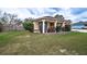 Inviting home featuring a well-manicured lawn, a cozy front porch, and a charming exterior at 125 Bergen Cir, Auburndale, FL 33823