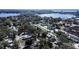 An aerial view showing a house nestled among trees in a lakeside community with nearby condos at 1325 4Th Ne St, Winter Haven, FL 33881
