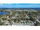 An aerial view showcasing the property's location amid lush trees, near a lake, with a baseball field in the distance at 1325 4Th Ne St, Winter Haven, FL 33881