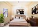 Modern bedroom with a wooden bed frame, neutral bedding, and stylish art at 1325 4Th Ne St, Winter Haven, FL 33881