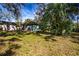 Exterior shot of house needing TLC with weathered walls and overgrown yard at 1325 4Th Ne St, Winter Haven, FL 33881