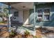 Exterior shot of house entrance needing TLC with weathered walls and overgrown yard at 1325 4Th Ne St, Winter Haven, FL 33881