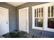 View of the screened front porch with gray walls, white trim, and a dark green floor at 1325 4Th Ne St, Winter Haven, FL 33881
