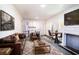 Open-concept living area with fireplace, dining space, and a comfortable seating area at 1325 4Th Ne St, Winter Haven, FL 33881