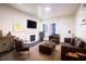 Inviting living room featuring comfortable leather furniture, a fireplace, and lots of natural light at 1325 4Th Ne St, Winter Haven, FL 33881