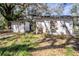 Exterior shot of two outbuildings needing complete renovation with weathered walls and overgrown yard at 1325 4Th Ne St, Winter Haven, FL 33881