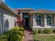 Inviting front entrance with brick walkway, decorative shrubbery, and manicured lawn at 1332 Oakmont Dr, Winter Haven, FL 33884