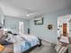 Spacious bedroom with calming blue walls, a television, and view into other rooms at 1332 Oakmont Dr, Winter Haven, FL 33884