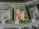 Aerial view of the house highlighting the roof, screened porch, and green backyard at 1336 Oakmont Dr, Winter Haven, FL 33884