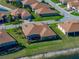 Overhead view of the residence, showcasing its screened in patio and pristine landscaping at 1336 Oakmont Dr, Winter Haven, FL 33884