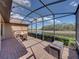 Enjoy serene water views from the brick-paved, screened back porch with comfortable seating at 1336 Oakmont Dr, Winter Haven, FL 33884