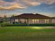 Beautiful backyard view of the home featuring lush grass and manicured landscaping at 1336 Oakmont Dr, Winter Haven, FL 33884