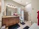 A full bathroom featuring a walk-in shower, granite countertops, and neutral tiling at 1336 Oakmont Dr, Winter Haven, FL 33884