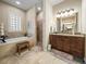 A neutral bathroom with a soaking tub, walk-in shower, double vanity with granite countertops at 1336 Oakmont Dr, Winter Haven, FL 33884