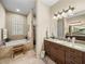 Well-lit bathroom features double vanity, granite countertops, a soaking tub, and a separate walk-in shower at 1336 Oakmont Dr, Winter Haven, FL 33884