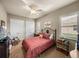 A cozy bedroom featuring a double bed, a ceiling fan, and a window with shutters at 1336 Oakmont Dr, Winter Haven, FL 33884
